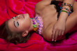 Glamorous Glossy Woman Lying on Red and  Daydreaming