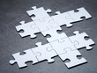Unfinished white jigsaw on stone floor