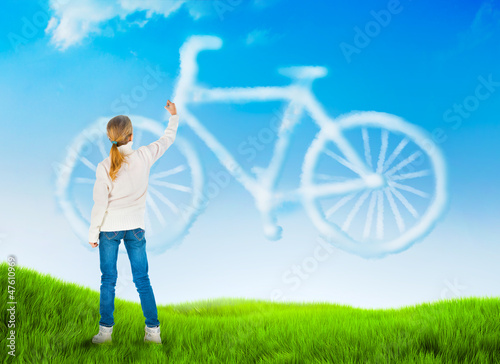 Photo: Beautiful nature background with a girl drawing bicycle Beautiful nature background with a girl drawing bicycle