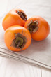 Exotic tropic orange fruits  persimmon served textile towel