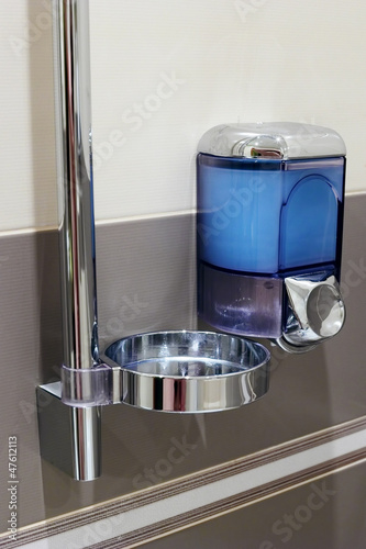 Photo: Soap dispenser in bathroom. Soap dispenser in bathroom.