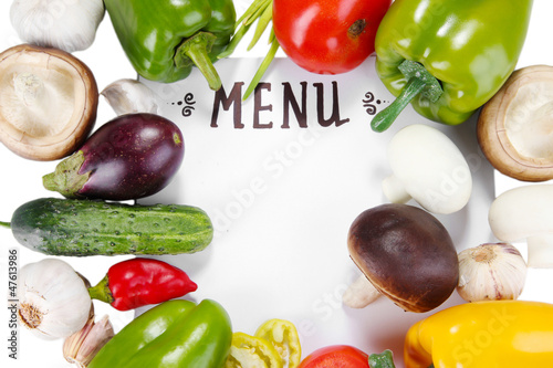 Photo: Menu surrounded by products and vegetables isolated on white Menu surrounded by products and vegetables isolated on white