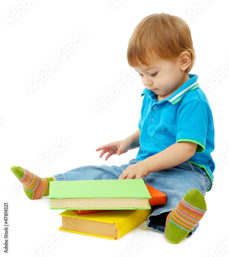 Photo: cute little boy with books, isolated on white cute little boy with books, isolated on white