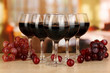 Red wine in glass on room background