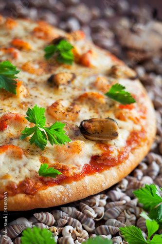 Photo: Pizza with seafood and spicy sauce, selective focus Pizza with seafood and spicy sauce, selective focus
