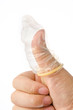 Photo: Hand with condom isolated on white Hand with condom isolated on white