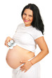 Happy pregnant woman with baby shoes