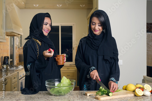 Photo: Two Arabian Women Cooking & Drinking coffee in the Kitchen Two Arabian Women Cooking & Drinking coffee in the Kitchen