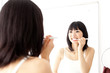 attractive asian woman brushing teeth