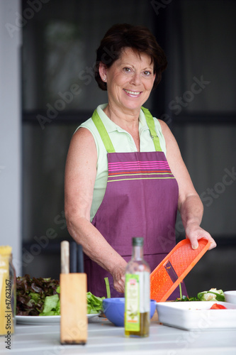 Photo: Older woman making a salad Older woman making a salad