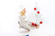 beautiful blonde woman holding a christmas gift is smiling