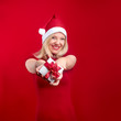 pretty young girl holding a christmas gift having fun