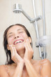 Photo: Woman washing face in shower Woman washing face in shower