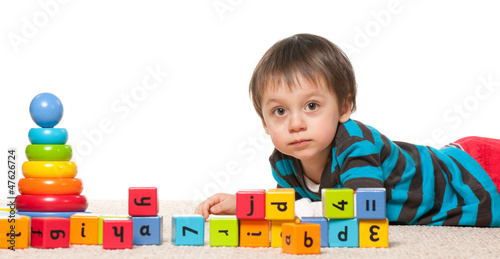 Photo: Little boy near blocks with alphabet Little boy near blocks with alphabet
