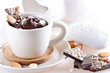 Photo: Cup of hot chocolate with pieces of chocolate and almond on ligh Cup of hot chocolate with pieces of chocolate and almond on ligh