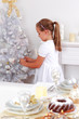 Cute girl decorating Christmas tree