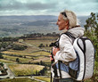Photo: Woman hiking on top of high cliff Woman hiking on top of high cliff