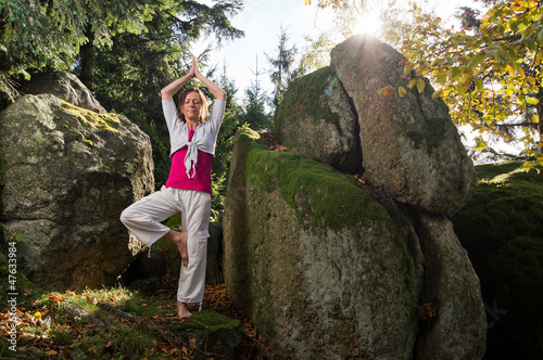 Photo: Woman Yoga standing between Rocks Woman Yoga standing between Rocks