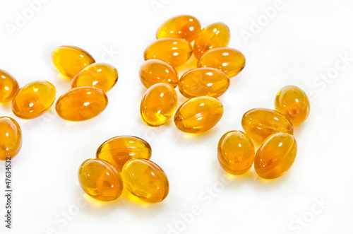 Photo: Rice bran oil pills on white background Rice bran oil pills on white background
