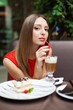 Attractive young woman has a rest in restaurant