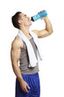 Muscular young man drinking in sports outfit