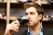 Man tasting a glass of red wine