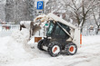 small excavator bobcat working on the street