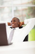 african american businessman daydreaming in office