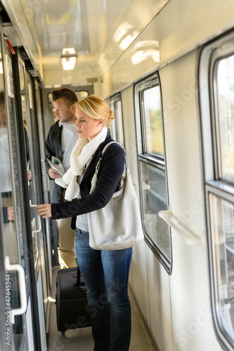 Photo: Woman opening the door of train compartment Woman opening the door of train compartment