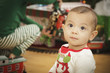 Infant Baby Enjoying Christmas Morning Near The Tree