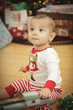 Infant Baby Enjoying Christmas Morning Near The Tree