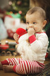 Infant Baby Enjoying Christmas Morning Near The Tree