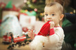 Infant Baby Enjoying Christmas Morning Near The Tree