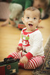 Infant Baby Enjoying Christmas Morning Near The Tree