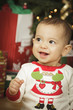 Infant Baby Enjoying Christmas Morning Near The Tree