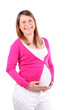 Smiling pregnant woman wearing in pink blouse holds her belly