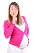 Pregnant woman wearing in pink blouse finger to her lips