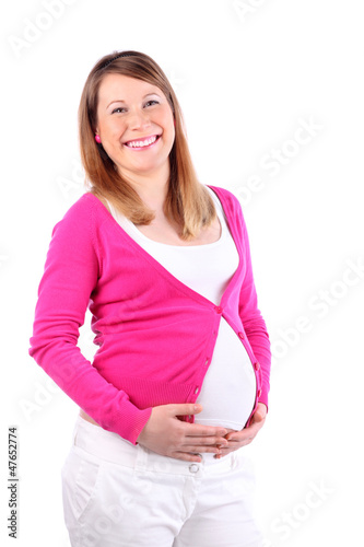 Photo: Smiling pregnant woman wearing in pink blouse holds her belly Smiling pregnant woman wearing in pink blouse holds her belly