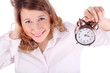 Awakening woman in white holds alarm clock isolated on white