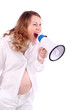 Pregnant woman in white shouts into megaphone isolated on white