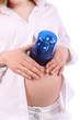Belly of pregnant woman in white which put blue flasher on belly