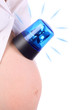 Belly of pregnant woman in white with blue flasher isolated