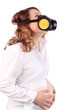 Pregnant suffering woman in white and respirator holds belly