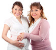 Pregnant woman in white smiles and her girlfriend