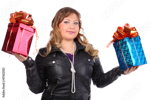 Photo: Beautiful woman wearing leather jacket holds boxes with gifts Beautiful woman wearing leather jacket holds boxes with gifts