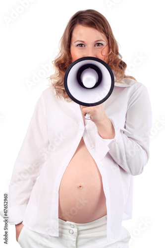 Photo: Pregnant woman in white speaks into megaphone isolated on white Pregnant woman in white speaks into megaphone isolated on white