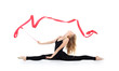 Beautiful ballerina in black suit sits on twine with red ribbon