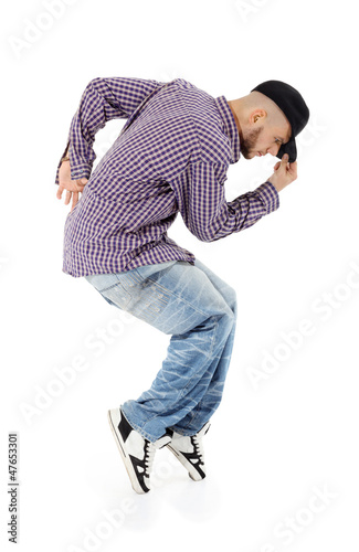 Photo: Young rapper in jeans and plaid shirt stands on tiptoe Young rapper in jeans and plaid shirt stands on tiptoe
