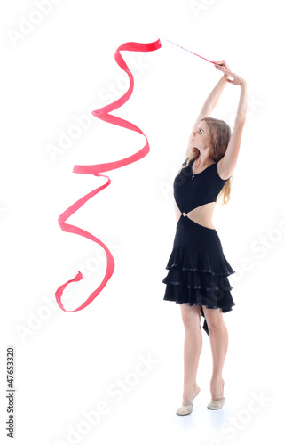 Photo: Young graceful gymnast in black dress with red ribbon Young graceful gymnast in black dress with red ribbon
