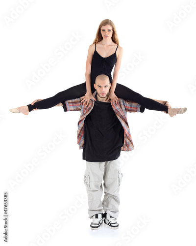 Photo: Breakdancer keeps on shoulders ballerina in black isolated Breakdancer keeps on shoulders ballerina in black isolated
